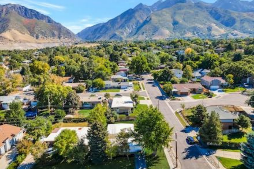 Homebuyer comparing Utah mortgage rates for a house near the Wasatch Mountains